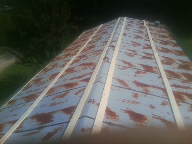 Rusted metal roof panels with new wood purlins before replacement — Storm Damage Roof Repair in Pollocksville by Roofing Brothers